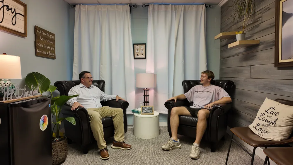 Brett Larsen and a client talking in the counseling room